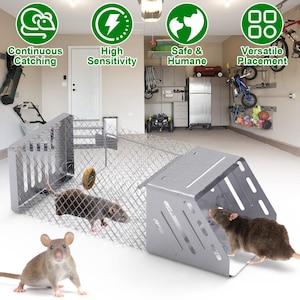 May include: A metal rat trap with a wire mesh enclosure and a hinged door. The trap is designed to catch rodents humanely. The image also shows a rat inside the trap and several icons with text: "Continuous Catching", "High Sensitivity", "Safe & Humane", and "Versatile Placement".