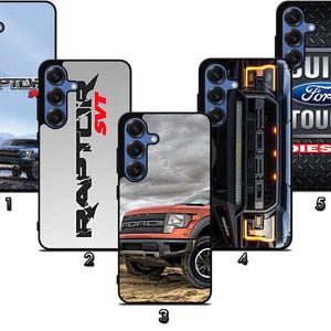 May include: A collection of five phone cases featuring Ford Raptor truck designs. The cases display images of the truck in various settings, including a mountain landscape and close-up shots of the vehicle's front. The cases have black borders.
