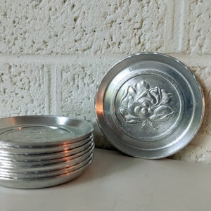 Eight Vintage Hammered Aluminum Coasters with Roses