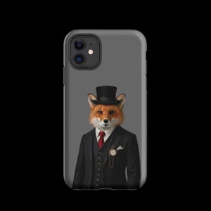 May include: A grey smartphone case featuring a graphic illustration of a fox wearing a black top hat, a black suit jacket, a black waistcoat, and a red necktie. A gold pocket watch with a chain is visible on the waistcoat, along with a white pocket square.