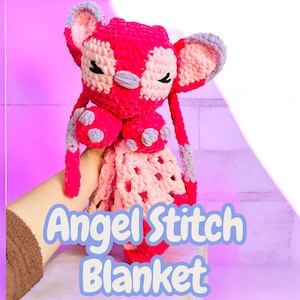 May include: A handmade, plush, pink and white Angel Stitch blanket. The crochet blanket features a character with large ears, closed eyes, and a patterned design. The text "Angel Stitch Blanket" is displayed in a blue font.