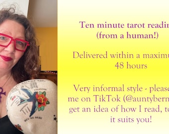 May include: A woman wearing red glasses and a purple pendant holds a decorative head with a tattoo-style design. Text on the right side of the image reads "Ten minute tarot reading (from a human!)" and "Delivered within a maximum of 48 hours."