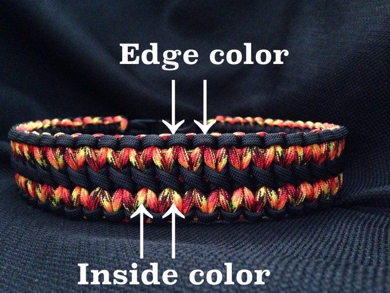 Pu&ograve; includere: Un braccialetto in paracord nero con un design a motivi rossi, gialli e neri. Il bordo del braccialetto &egrave; nero e l'interno &egrave; rosso, giallo e nero.