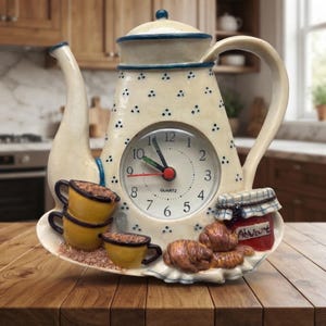 May include: A cream-colored ceramic teapot-shaped clock with blue trim and small blue triangular patterns. It features a central quartz clock face, a stack of two yellow cups, a third yellow cup, and a red jam jar with a checkered lid.