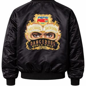 May include: Black satin bomber jacket featuring a gold embroidered design with the text "MICHAEL JACKSON DANGEROUS WORLD TOUR" and the Pepsi logo. The jacket has black ribbed cuffs and hem.