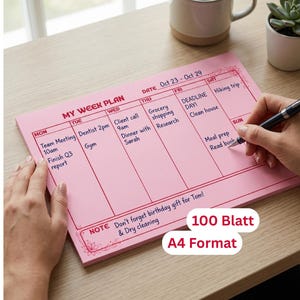 Könnte beinhalten: Ein rosa Wochenplaner mit dem Text "MY WEEK PLAN" und den Daten 23. bis 29. Oktober. Der Planer hat Abschnitte für jeden Wochentag mit handschriftlichen Notizen. Der Text "100 Blatt" und "A4 Format" sind ebenfalls sichtbar.