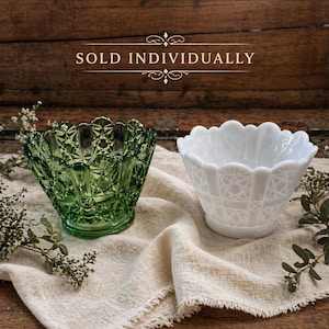 May include: Two decorative glass bowls. One is green, the other is white. Both have a textured, geometric pattern and scalloped edges. The text "SOLD INDIVIDUALLY" is above the bowls.