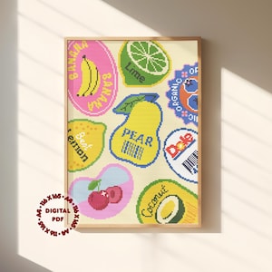 May include: A cross-stitch pattern featuring various fruit icons including a banana, lime, pear, lemon, cherry, and coconut. Each fruit is labelled with text like Banana, Lime, Pear, Lemon, and Coconut, set against a cream background in a wooden frame.