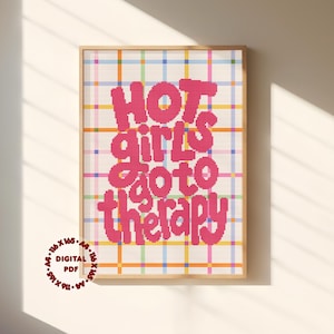 May include: A cross-stitch pattern featuring the pink text "HOT girls go to therapy" set against a white background with a multi-colored plaid grid of blue, yellow, green, and pink lines. A circular stamp reads "116 x 165", "A4", and "DIGITAL PDF".