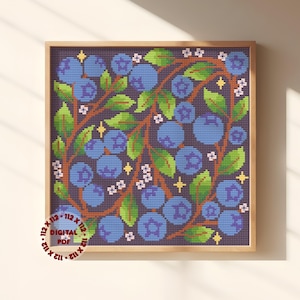 May include: A cross-stitch pattern featuring blue blueberries and green leaves on a dark purple background, accented with small white flowers and yellow star shapes. A circular red stamp in the corner reads 112 x 112 DIGITAL PDF.