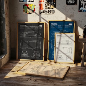 May include: Framed Aston Martin DBS specifications prints in black, blue, and white. The prints feature detailed car schematics and are displayed on a wooden floor. A black helmet rests on a small wooden stool.