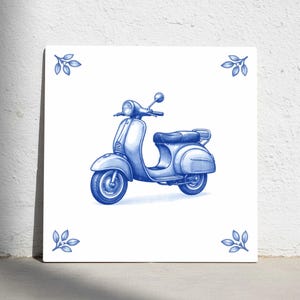 May include: A blue and white tile featuring a detailed illustration of a vintage scooter. The scooter is rendered in shades of blue, with a classic design. Decorative leaf motifs are in each corner.