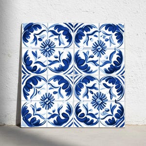 May include: A square arrangement of twelve ceramic tiles with a repeating blue and white floral pattern. Each tile features a central flower surrounded by stylized leaves and vines, creating a cohesive design. The tiles are arranged in a grid.