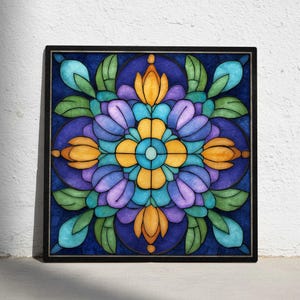 May include: A square, framed artwork featuring a stained-glass design. The artwork showcases a symmetrical floral pattern with a central flower in yellow and turquoise, surrounded by purple, blue, and green petals and leaves. The frame is black.