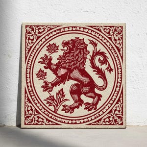 May include: Square tile with a red lion rampant design. The lion is encircled by a decorative border and maple leaves. The tile has a cream-colored background and a red lion illustration.