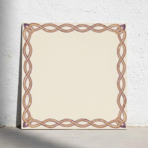 May include: A square ceramic tile featuring a solid cream-colored center surrounded by a decorative border of intertwined tan and purple rope patterns. The design creates a continuous frame around the perimeter of the flat, smooth surface.
