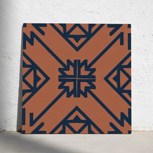 May include: Square terracotta-colored tile with a repeating geometric pattern in navy blue. The design features symmetrical shapes, including triangles and a central cross-like motif. The tile is displayed against a white background.