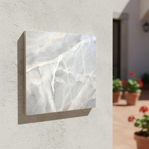 May include: A white ceramic mug with a black handle and the text "But First, Coffee" in a black, bold font. The mug is on a white surface.