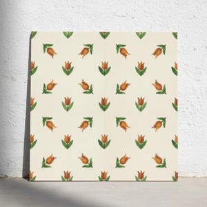 May include: A square tile featuring a repeating pattern of small orange tulips with green leaves arranged in a grid on a cream-coloured background. The floral design is evenly spaced across the surface, showcasing a consistent botanical motif.