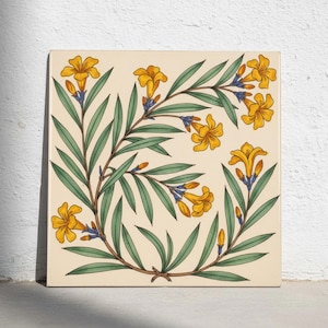 May include: A square ceramic tile featuring a botanical illustration of yellow trumpet-shaped flowers with green lanceolate leaves and small blue accents on a cream-coloured background, arranged in a curved, flowing vine-like pattern across the surface.