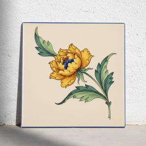 May include: A square ceramic tile with a cream-colored background featuring a hand-painted illustration of a large yellow flower with a dark blue center and detailed green leaves. The tile has a thin blue border along its four straight edges.