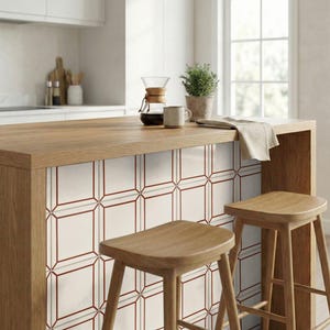 Puede incluir: Una taza de cerámica blanca con asa negra y el texto "But First, Coffee" en negrita negra. La taza se encuentra sobre un fondo borroso, sugiriendo un ambiente acogedor.