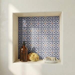 Portuguese-inspired ceramic tile design with nautical circles and small terracotta-style accent marks.