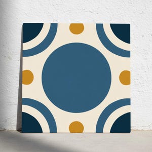 May include: Square canvas art featuring a geometric pattern. The design includes a large, central blue circle, surrounded by smaller gold circles and navy blue semi-circles on a cream background. The artwork is displayed against a white wall.