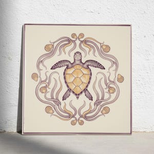 May include: A square decorative tile featuring a central illustration of a sea turtle with a yellow shell and purple patterned skin. The turtle is surrounded by a circular border of stylised purple seaweed and small yellow seashells on a cream background.