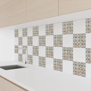 May include: White and patterned ceramic tiles with nautical motifs, including anchors, shells, and fish. The tiles are arranged in a checkerboard pattern, creating a decorative backsplash. The tiles are installed above a white countertop.
