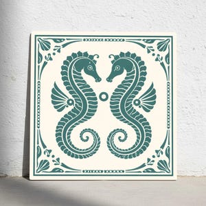 May include: Square tile featuring a teal seahorse design. Two seahorses face each other, surrounded by a decorative border with floral and chain-like elements. The background is a cream color.