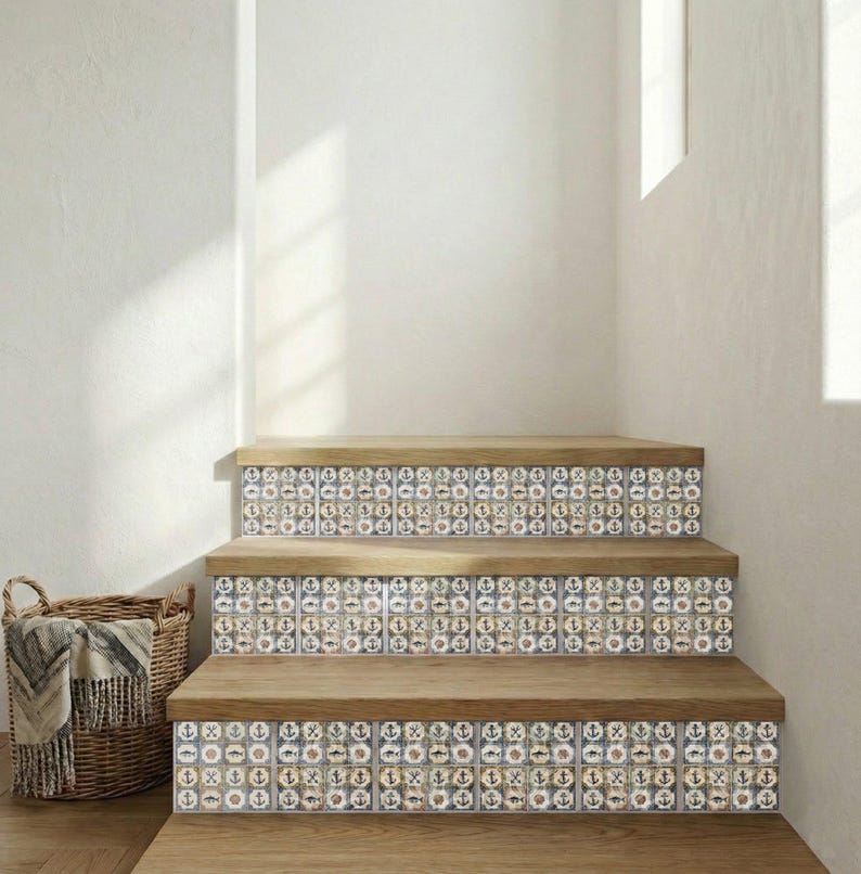 May include: Wooden staircase with decorative tiles featuring nautical symbols. The tiles have a blue, white, and tan color scheme. The steps are made of light brown wood. A woven basket with a blanket is in the corner.