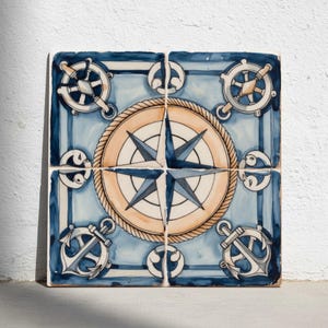 May include: Four square ceramic tiles with a nautical theme. Each tile features a blue and white design with a compass rose, ship wheels, and anchors. The compass rose is in the center, surrounded by a rope design.