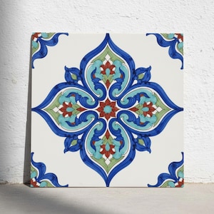 May include: A square ceramic tile featuring a symmetrical floral pattern in shades of deep blue, turquoise, light green, and dark red against a white background. The design consists of intricate, curved, and pointed petal-like shapes.