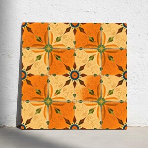 May include: Square tile with a repeating pattern of orange, yellow, and green floral designs. The tile features a symmetrical arrangement of stylized flowers and swirling patterns, creating a decorative and artistic look.