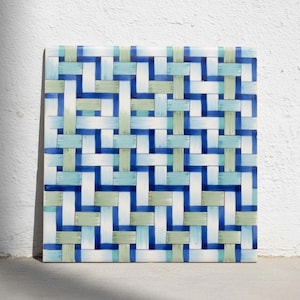 May include: A square ceramic tile featuring a repeating woven pattern in shades of deep blue, light turquoise, and pale sage green. The design consists of intersecting horizontal and vertical bands that create a grid-like appearance across the surface.