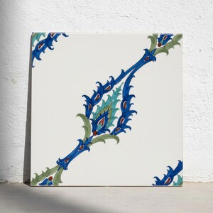May include: A square ceramic tile with a white background featuring a central diagonal floral motif in shades of cobalt blue, turquoise, and dark red. The design extends from the top left to the bottom right corner with intricate leaf patterns.