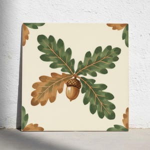 May include: A square ceramic tile with a cream-coloured background featuring a central illustration of an acorn with green and brown oak leaves. Additional partial oak leaf designs are positioned in each of the four corners of the tile.
