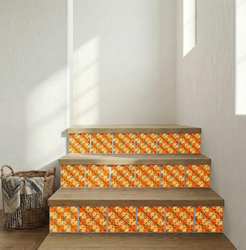 May include: Wooden staircase with decorative tiles featuring an orange and yellow floral pattern. The tiles are installed on the risers of the steps. A woven basket with a blanket is visible in the corner.