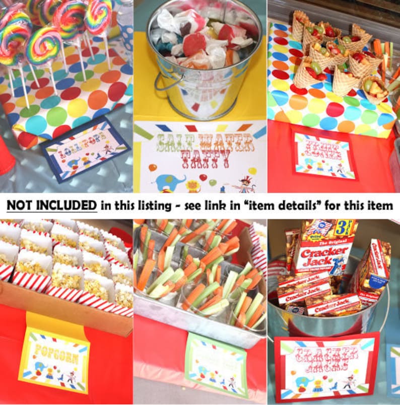 May include: A circus-themed party food table with various snacks, including popcorn, lollipops, pretzels, and fruit. The table is decorated with red and white striped paper and colorful polka dots. The signs on the table read "Lollipops", "Popcorn", "Pretzels", and "Salt Water Taffy".