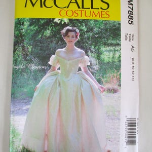 May include: McCall's Costumes sewing pattern featuring a woman in a light green and pink ball gown. The pattern includes sizes A5 (6-8-10-12-14). The pattern is labeled M7885 and designed by Angela Clayton.