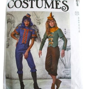 May include: McCall's Costumes pattern showing two costume designs. One is a blue jumpsuit with a zig-zag pattern, the other a green jacket and brown trousers. The pattern includes the text "COSTUMES".