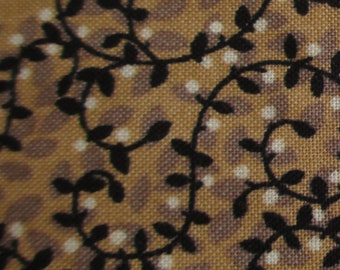May include: Close-up of a brown fabric with a repeating pattern of black vines and white dots.