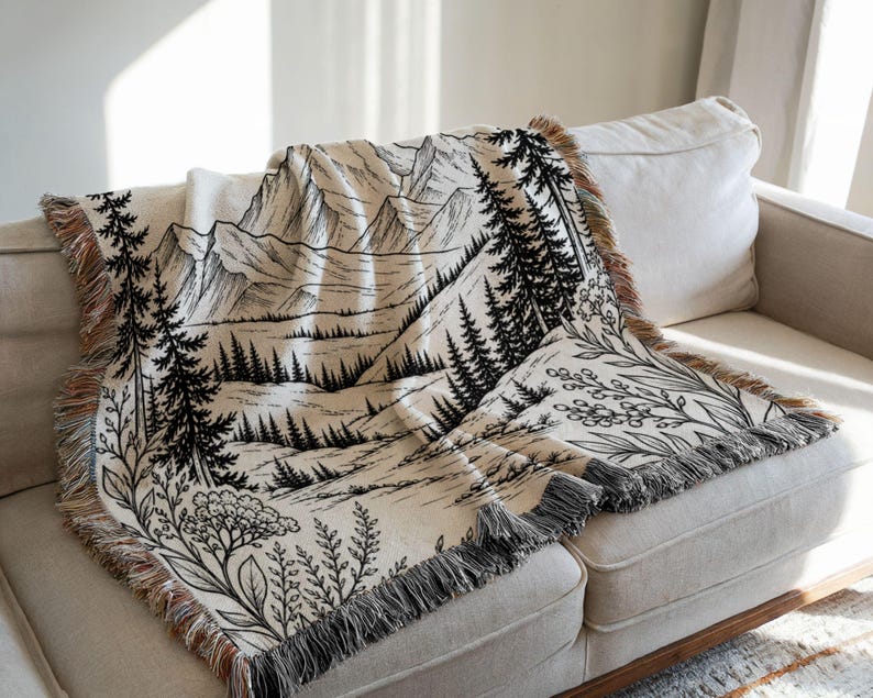 Personalized mountain woven blanket with custom couple names and date, featuring forest trees and rustic mountain landscape art, styled as cozy cabin wall decor for wedding, engagement, or anniversary gift.