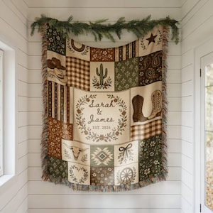 May include: A woven throw blanket featuring a patchwork design with western-themed illustrations including cowboy hats, boots, a cactus, a steer skull, and a floral wreath with the text Sarah & James EST. 2026 in a neutral color palette.