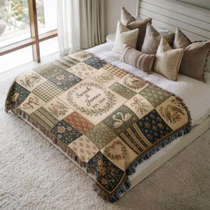 May include: A personalized patchwork throw blanket with a variety of patterns, including floral, birds, and hearts. The center square features the names "Sarah & James" and the year "EST. 2026" within a wreath. The blanket has a fringed edge.