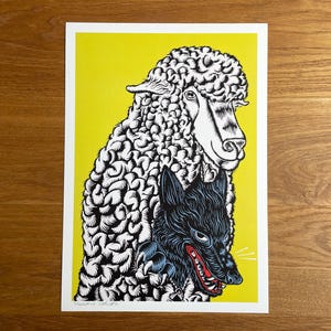 Puede incluir: Lámina artística que representa una oveja y un lobo. La oveja es blanca con un patrón de lana texturizada, y el lobo es negro con detalles rojos. El fondo es amarillo brillante y la impresión es sobre papel blanco.