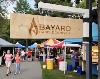 May include: A rectangular light-colored wooden sign hanging from a white metal bracket. The sign features a dark brown laser-engraved flame icon and the text BAYARD CANDLE COMPANY. The sign is suspended by two silver metal eye bolts and hooks.