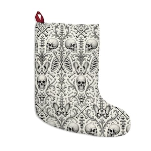 May include: A holiday stocking featuring an off-white background with a repeating black and gray anatomical pattern of human skulls, rib cages, pelvic bones, spinal columns, and crossed bones, finished with a small dark red hanging loop.
