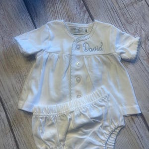 May include: A rustic wooden sign with the text "Welcome to our home" in a handwritten style. The sign features a distressed finish and a simple, inviting design, perfect for entryway decor.